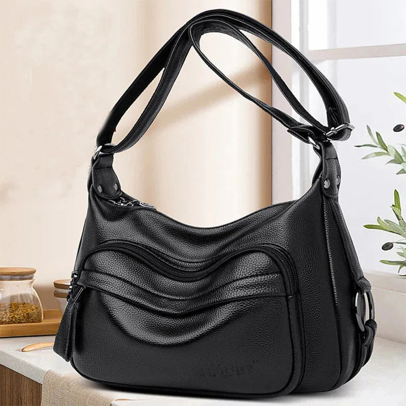 Blue women's large crossbody shoulder bag with multiple internal compartments and soft horizontal square design