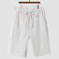 Man wearing beige linen cropped shorts with a loose fit and elasticated waist