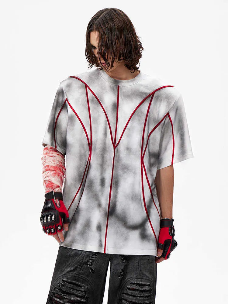 Women's padded shoulder short sleeve T-shirt with textured line patchwork design on front.