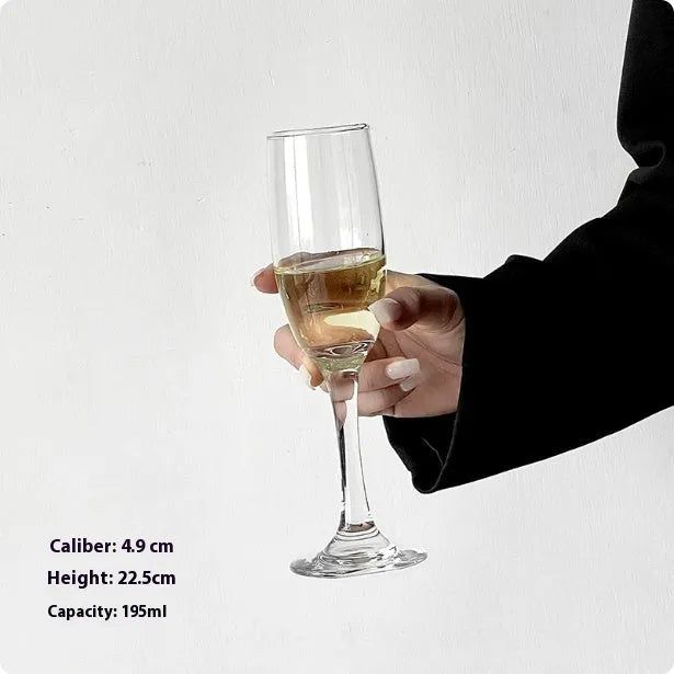 A single clear French goblet champagne glass on a table.