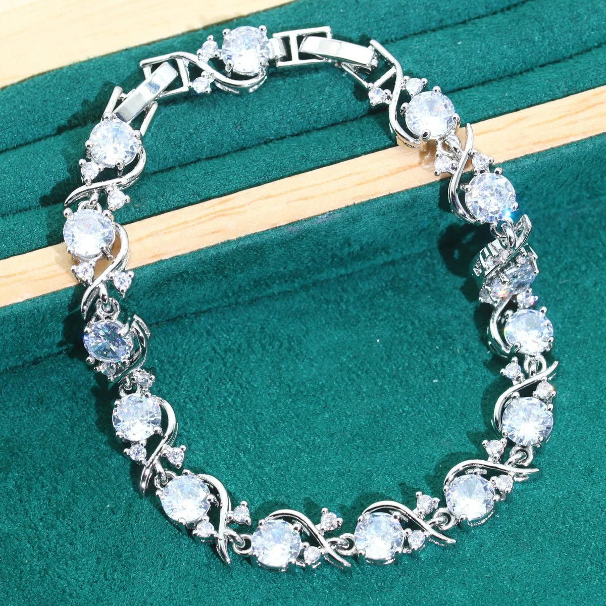 Bridal zircon four-piece jewellery set with necklace, earrings, bracelet, and ring in water wave chain style.