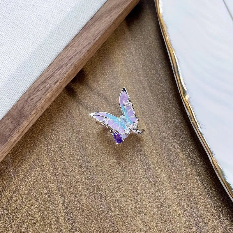 Copper adjustable insect ring on a finger, showing its irregular design and adjustable opening.