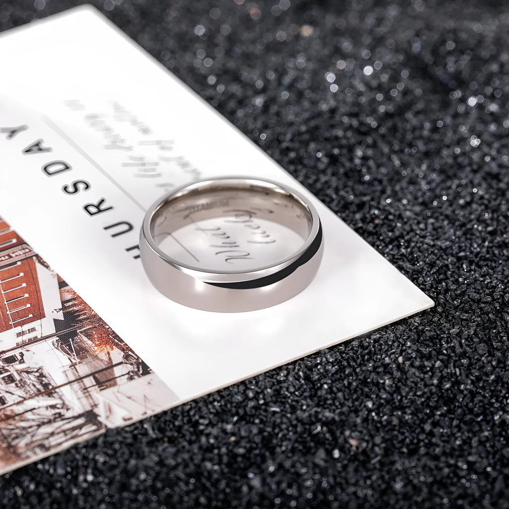 Silver-coloured titanium steel ring shown in minimalist style with unisex sizing.