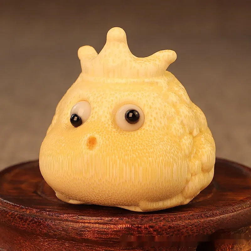 Close-up of a 5 cm cute Crown Princess Toad ornament carved from solid bamboo.