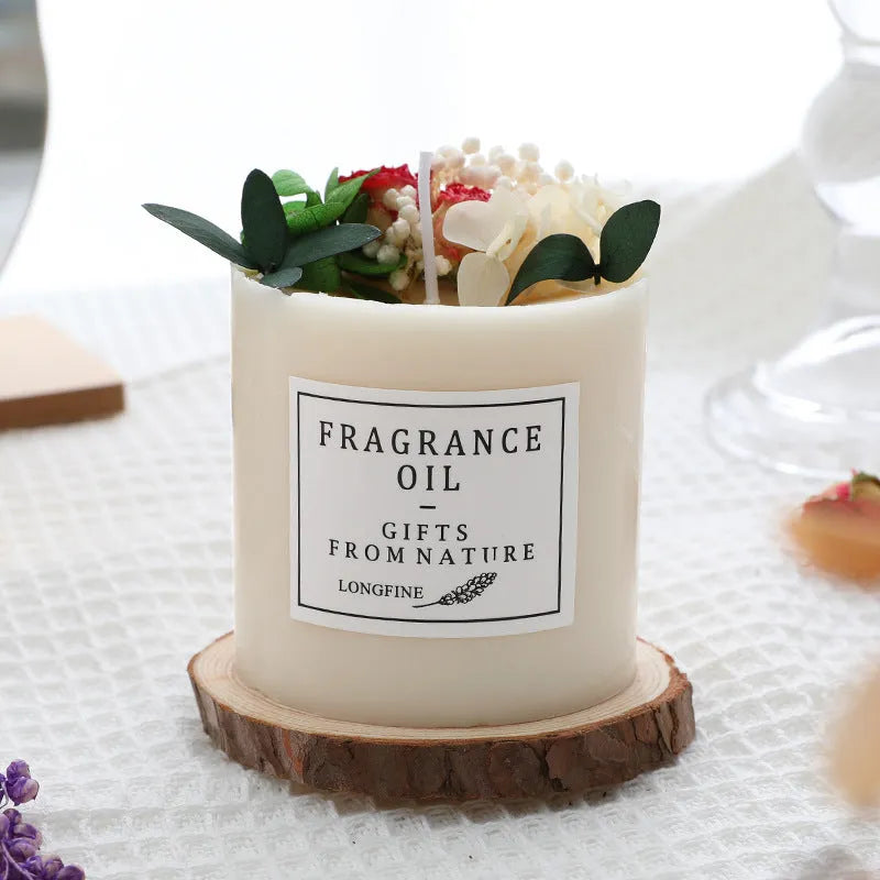 Decorative aromatherapy candle with dried flowers embedded in solid wax, shown with optional wooden chip base.