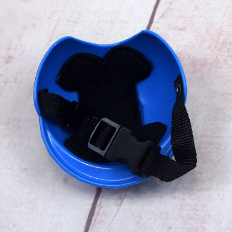 A pink plastic motorcycle cap helmet for a dog, shown alongside white, black, and yellow colour options.