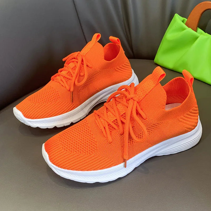 Women's cream running shoes with breathable mesh upper and flat rubber sole