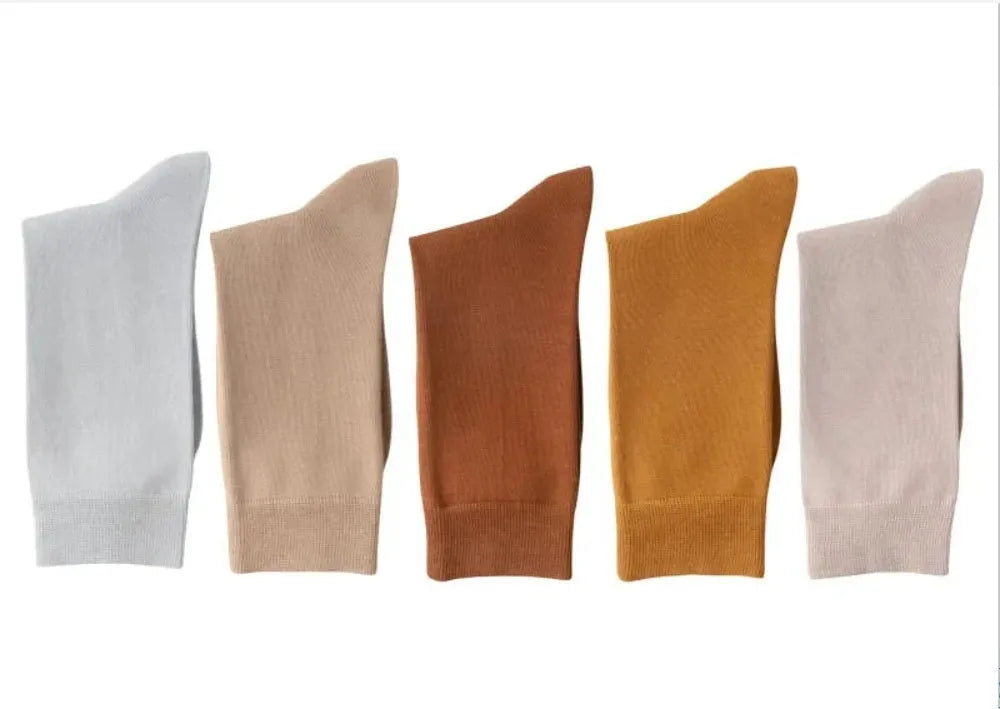 Men's solid colour pure cotton mid-calf business socks in beige, black, grey and blue shown folded.