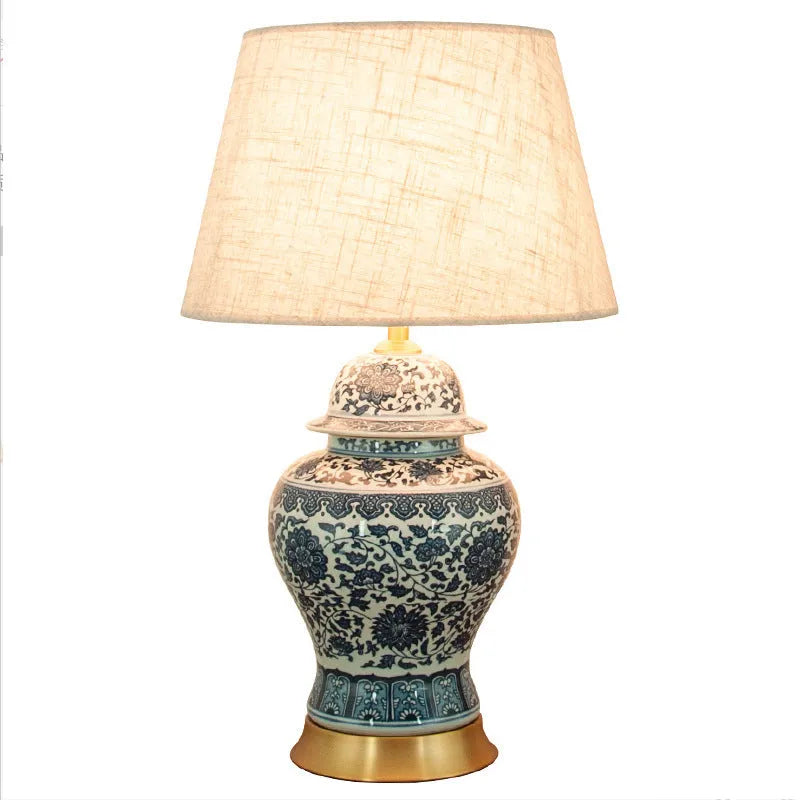 Handmade blue and white Chinese porcelain ceramic table lamp with copper base and fabric shade.