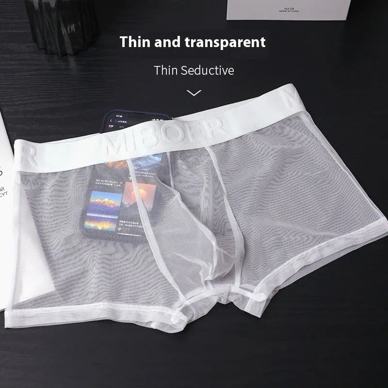 Men's thin solid-colour boxer shorts in black, white, blue, green, pink, and skin colour.