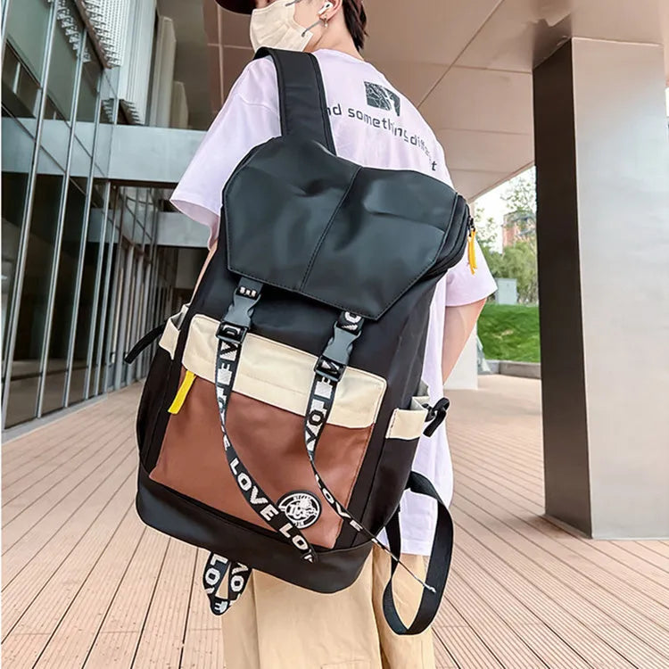 Oxford cloth backpack in black, green, or red with adjustable carrying straps.