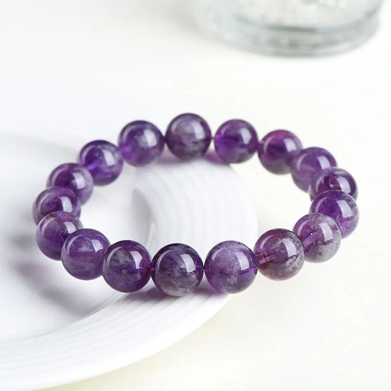 Natural feather amethyst crystal bracelet with geometric shape and silver fastener on wrist.