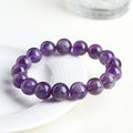 Natural feather amethyst crystal bracelet with geometric shape and silver fastener on wrist.