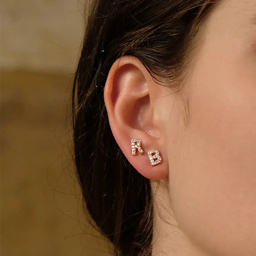 Brass gold plated alphabet letter earrings showing English character design with zircon elements