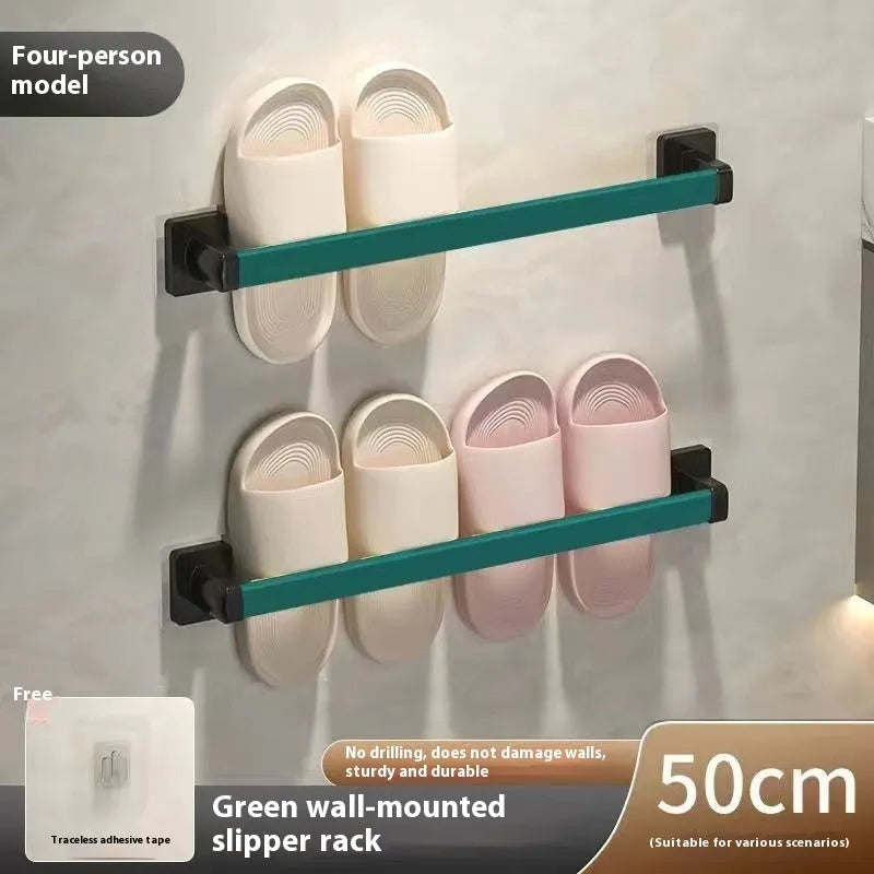 Black wall-mounted slipper rack with a small seat, shown holding two pairs of slippers.