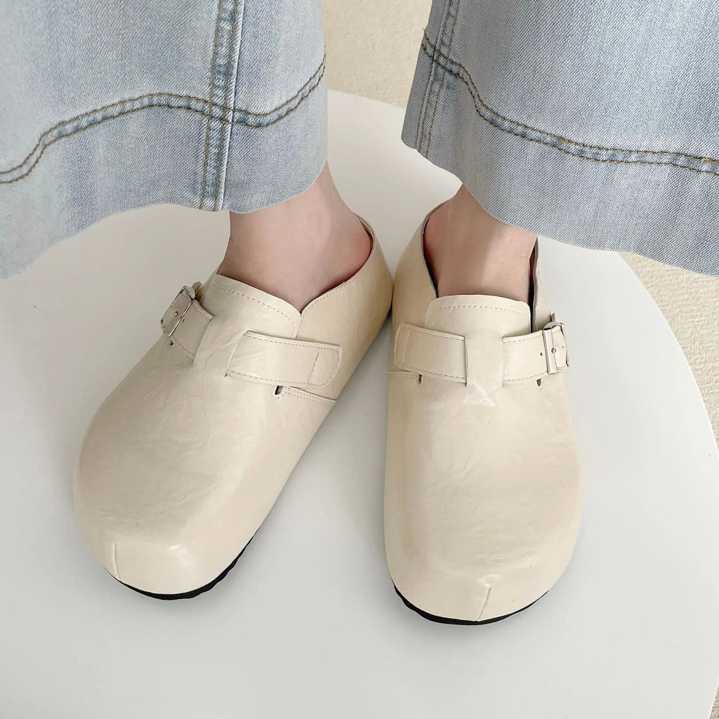 Flat buckle casual sneakers in yellow, black, silver, and creamy-white on a white background.