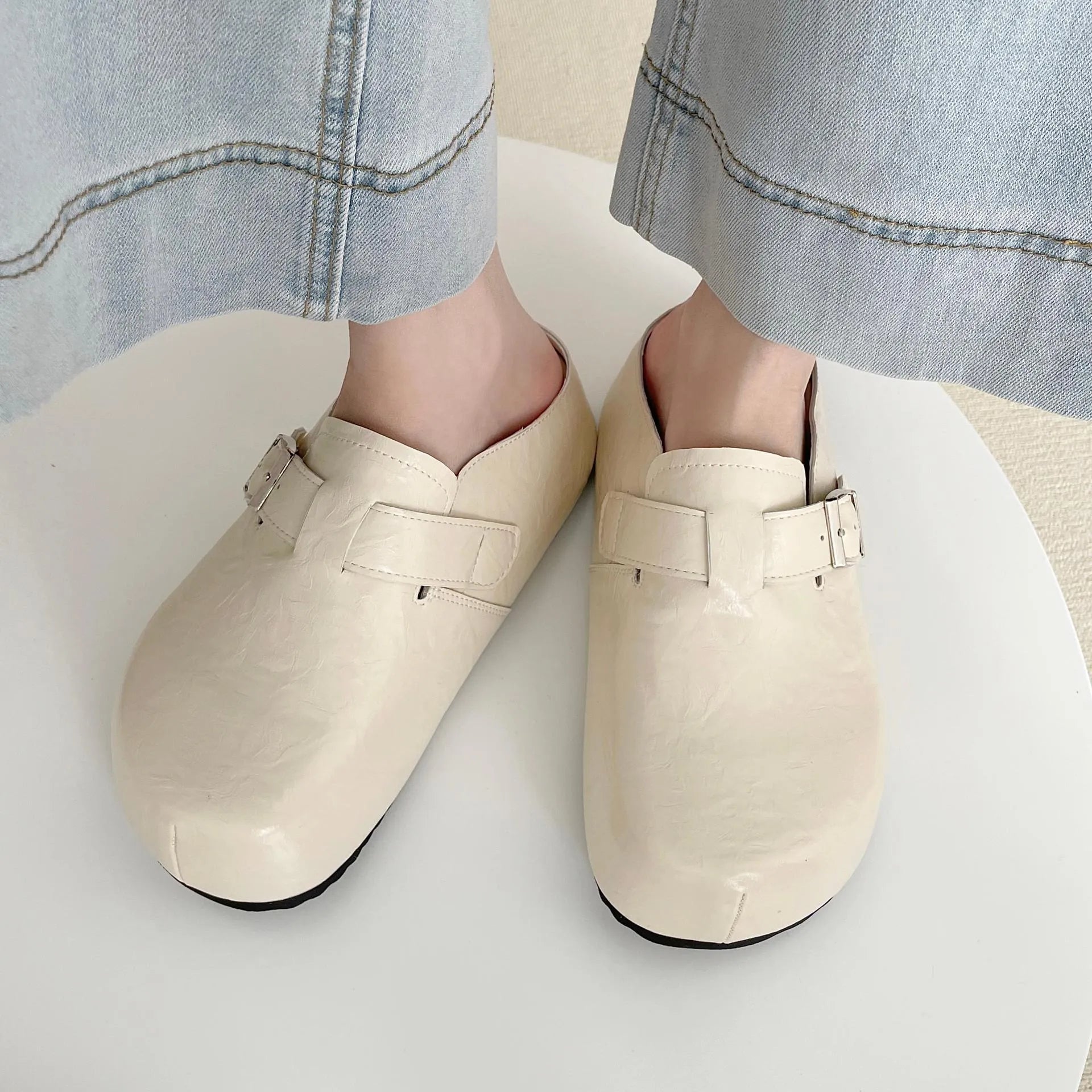 Flat buckle casual sneakers in yellow, black, silver, and creamy-white on a white background.