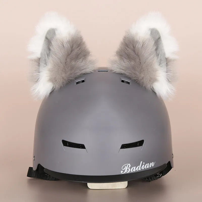 Plush fabric ski helmet decoration with cartoon design on a black ski helmet.