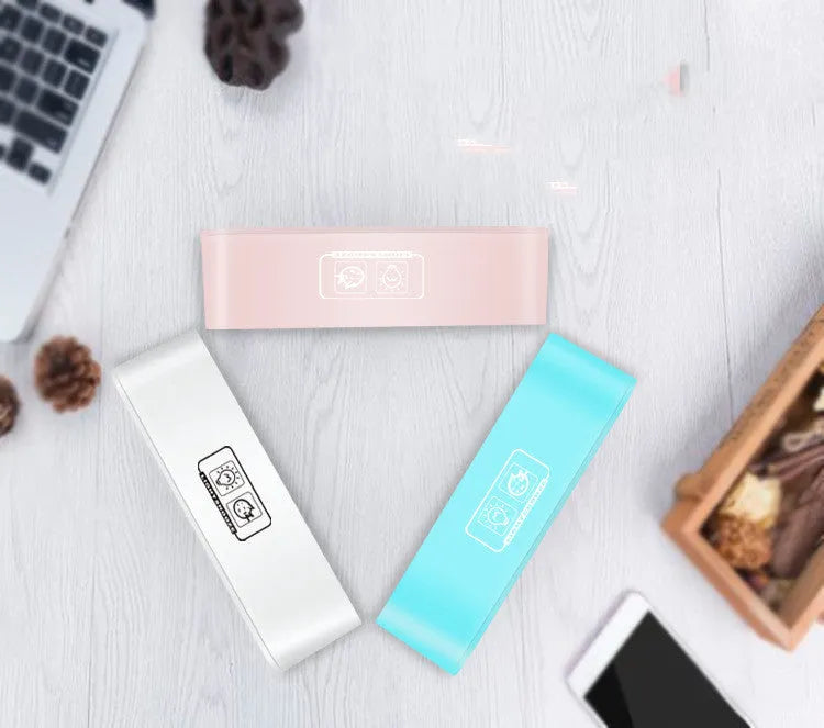 Blue rectangular LED atmosphere light alarm clock with digital display on a desk.