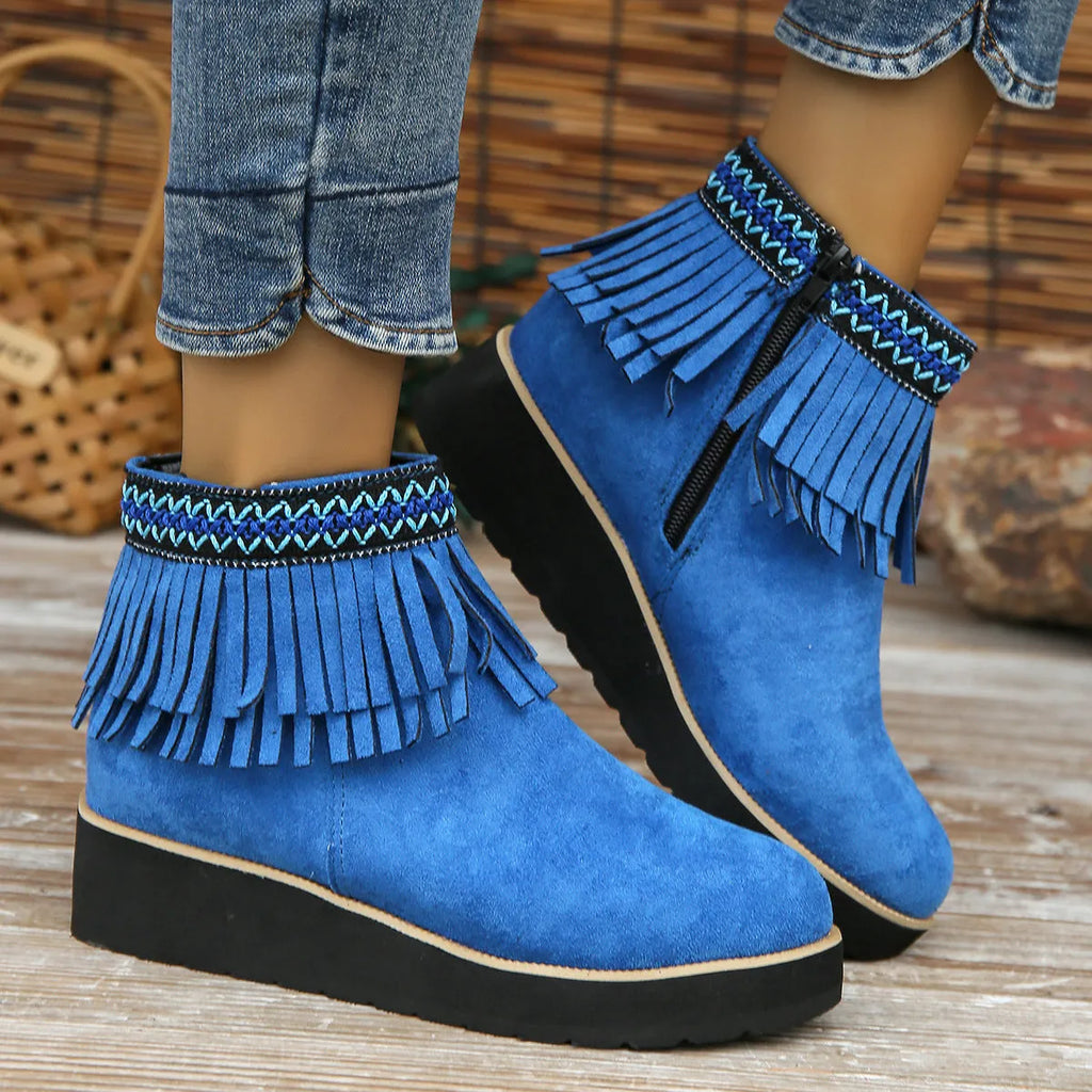 Women's dark brown suede ankle boots with a wedge heel, side zip, and decorative tassel detail.