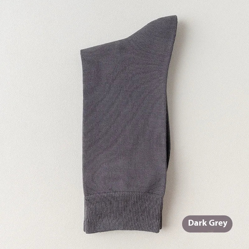 Men's solid colour pure cotton mid-calf business socks in beige, black, grey and blue shown folded.