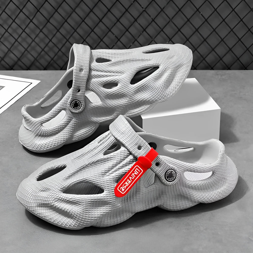 Men's grey EVA slippers with closed toe and breathable hole design on foot