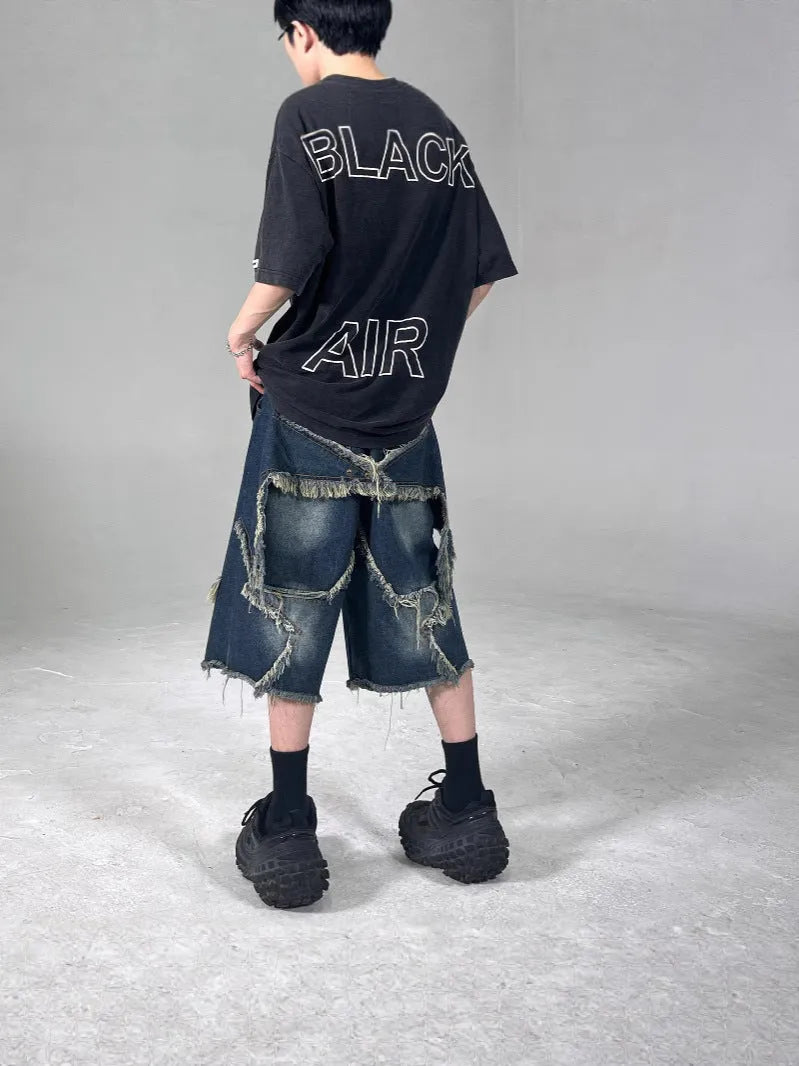 Blue denim shorts with American retro style, frayed detailing, and five-pointed star patches