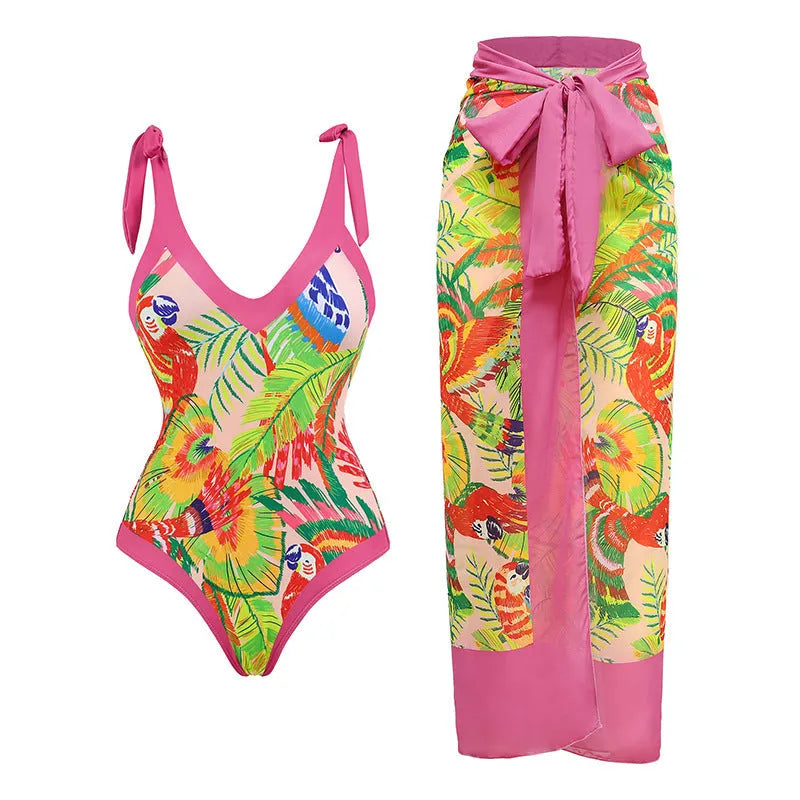 Women's pink floral print one-piece swimsuit with V-neck and a separate cover-up skirt.