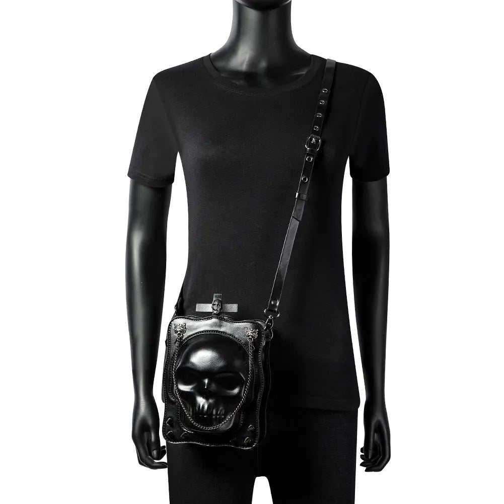Black mini square crossbody bag with 3D embossed skull design and chain strap