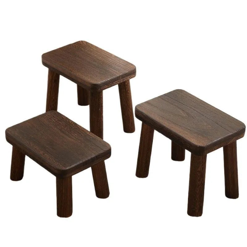 Solid wood shoes changing stool with distressed finish and bracket leg structure.