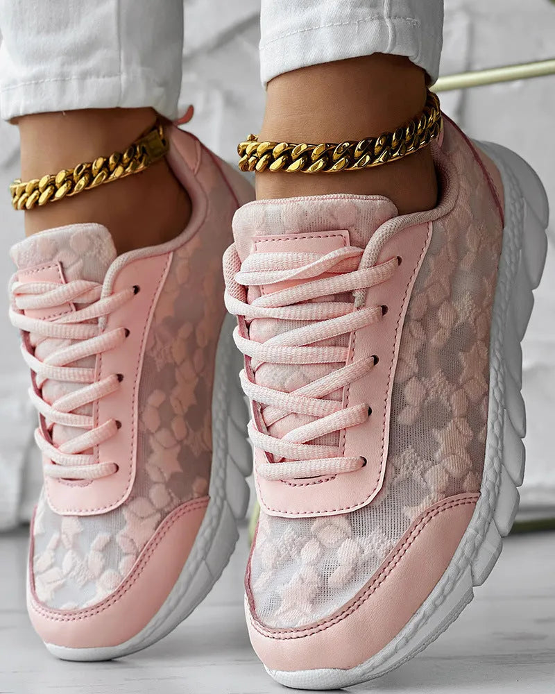 Women's white canvas casual sports running shoe with round toe and flat heel on a neutral background.