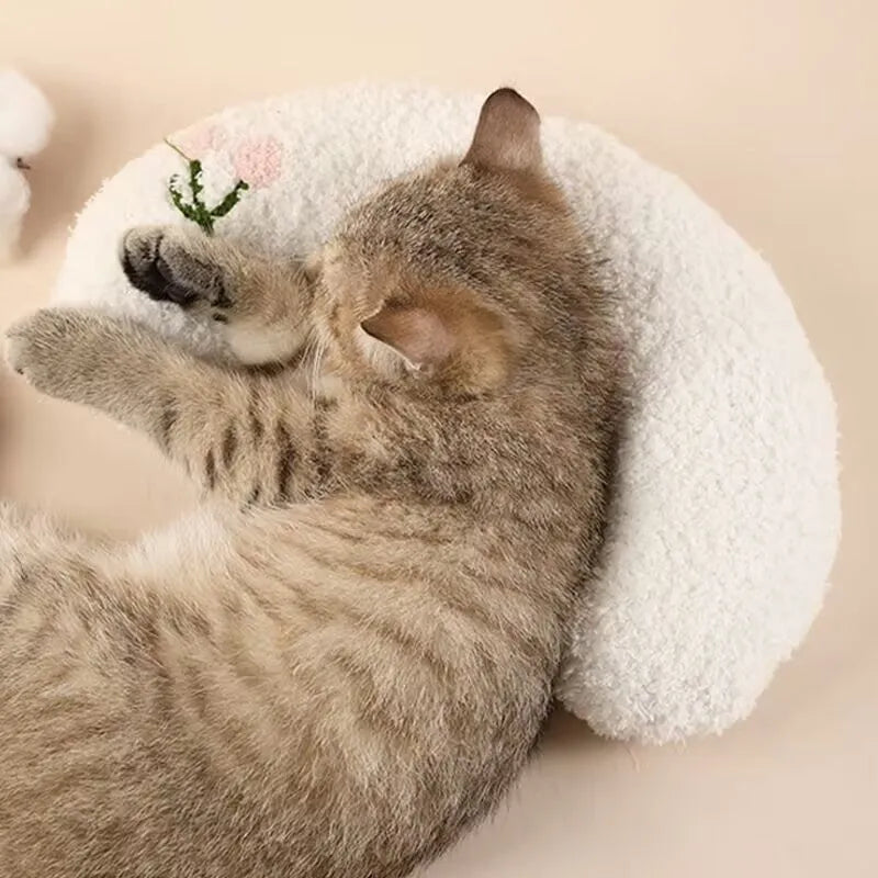 Blue moon-shaped and yellow question mark-shaped cloth pillows for cats, showing U-shaped neck support design.