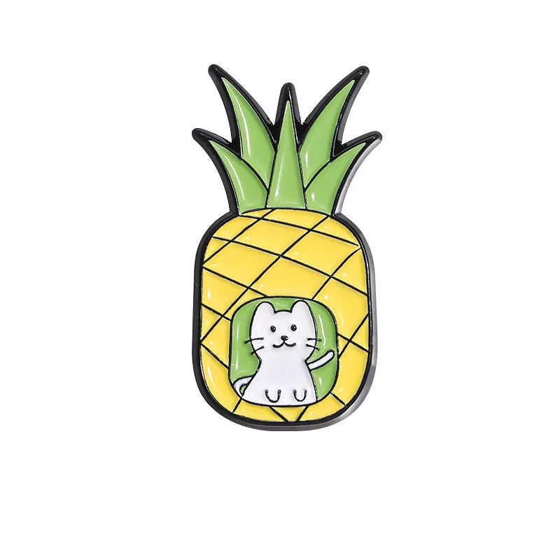 Colourful cartoon fruit design metal brooch pin on a fabric background.