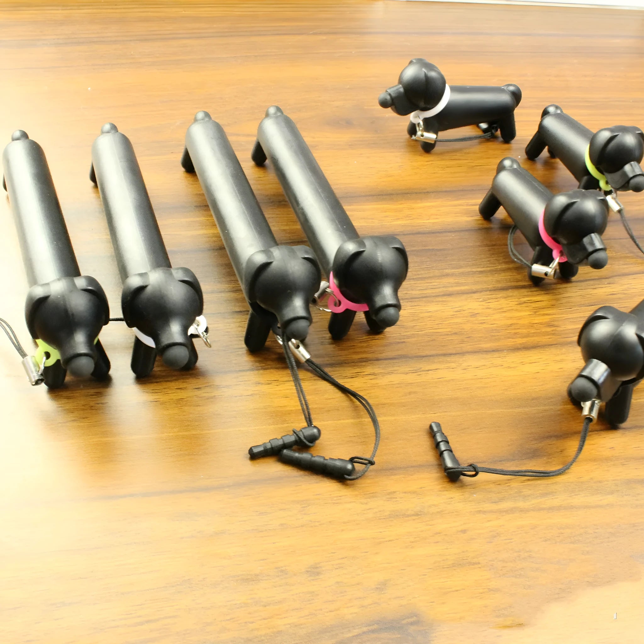 Black dog-shaped touch screen stylus with 12cm length shown on desk
