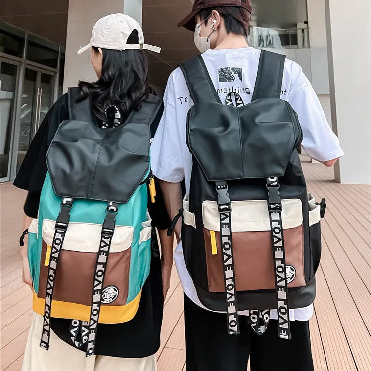 Oxford cloth backpack in black, green, or red with adjustable carrying straps.