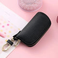 Simple black PU zipper key ring case for car and home keys on a grey background.