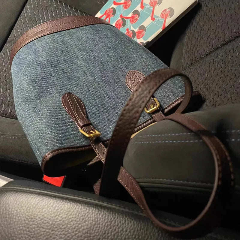 Large denim patchwork bucket handbag showing adjustable strap and retro styling