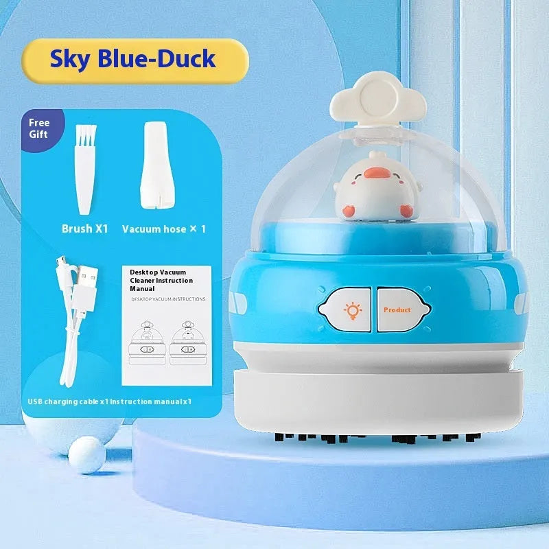 Blue handheld USB desktop vacuum cleaner on a wooden desk next to a keyboard.