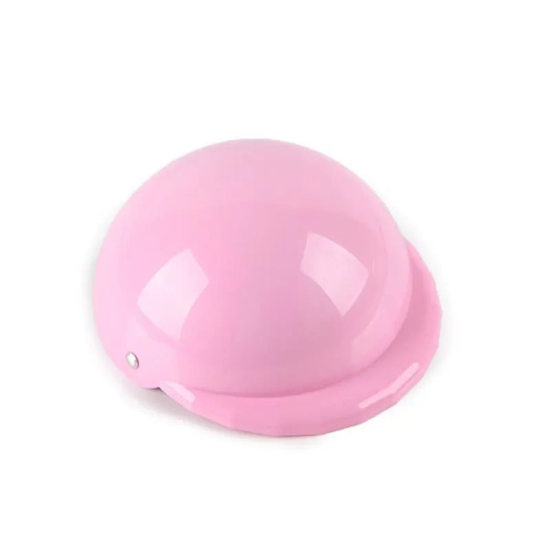 A pink plastic motorcycle cap helmet for a dog, shown alongside white, black, and yellow colour options.