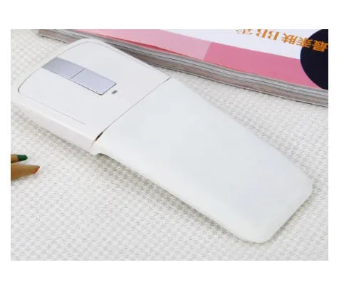 Folded Bluetooth wireless mouse showing compact 131.2mm length with touch surface and multiple colour options