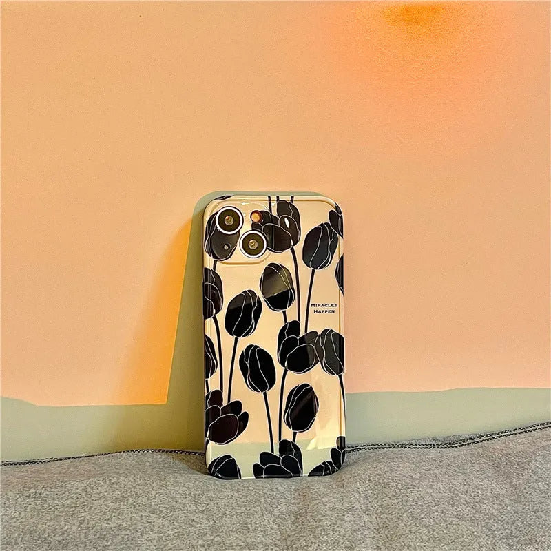 Black silicone iPhone case with a detailed tulip flower print on the back.
