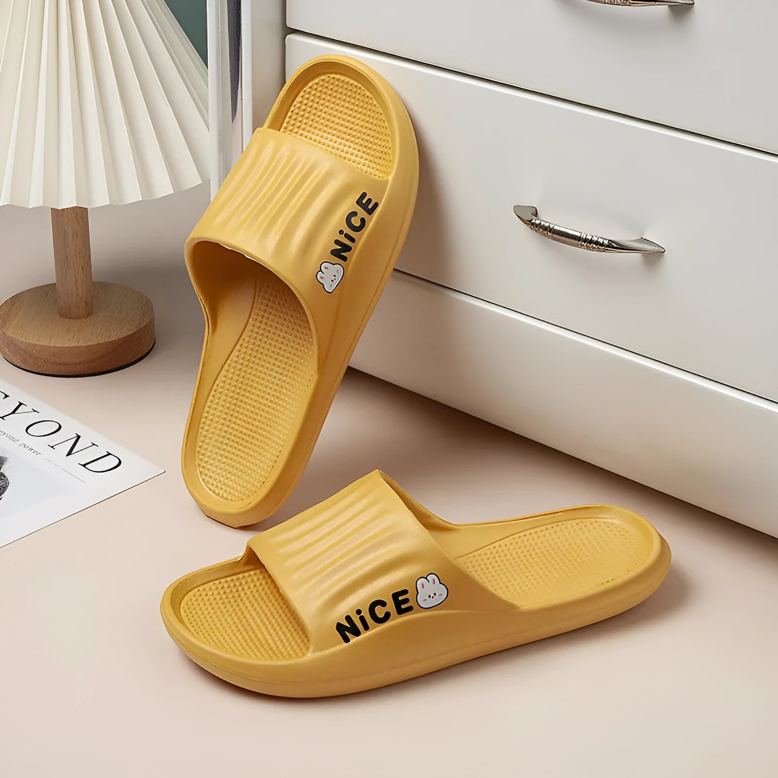 Pair of minimalist EVA flip flop slippers in a choice of six colours, showing the injection moulded non-slip sole.