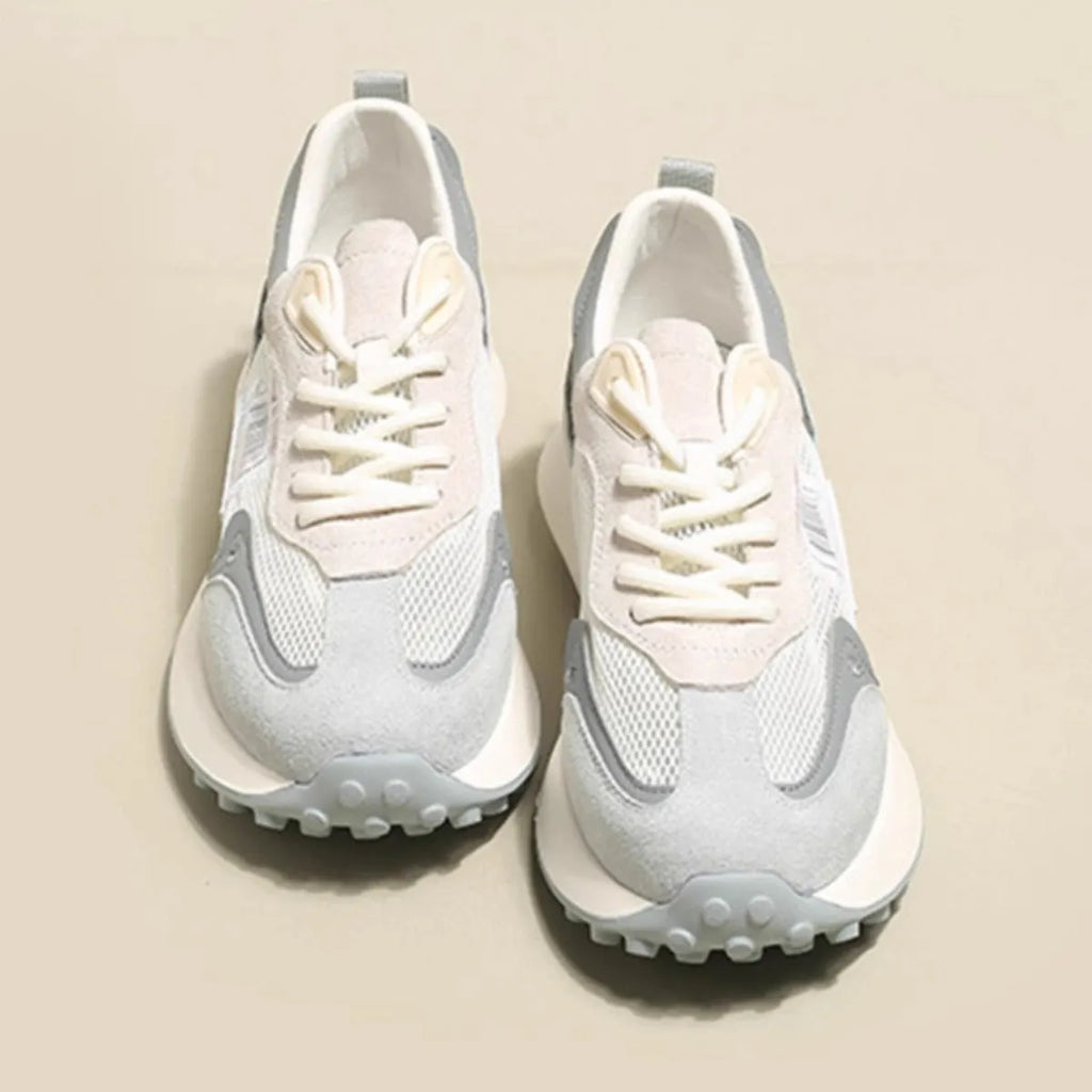 Women's grey and pink retro sneakers with mesh lining, rubber sole, and round toe design