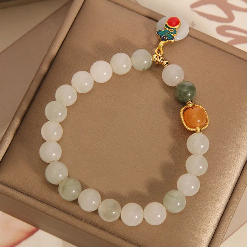 Women's ice jade bracelet with a pearl on the jade buckle.