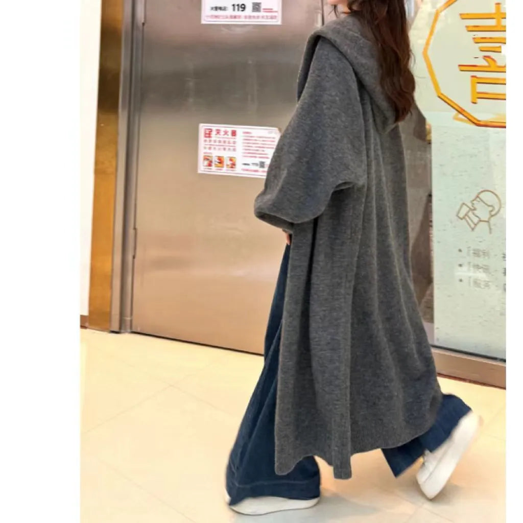 Women's long hooded cardigan in wool blend fabric showing below-the-knee length and loose fit silhouette
