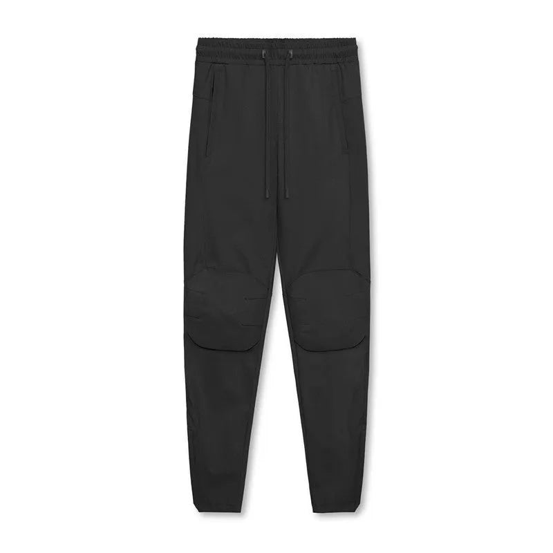 Men's loose fit quick-dry running pants with ankle ties in woodland camouflage and solid colours for gym fitness training.