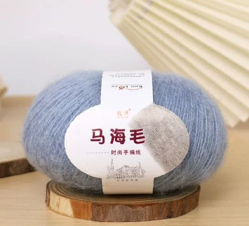 DIY mohair scarf weaving kit showing one wool ball and a selection of 34 colour options including white, pink, blue and green.