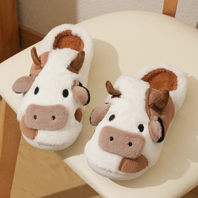 White cow design slippers with plush faux fur upper and textured non-slip sole