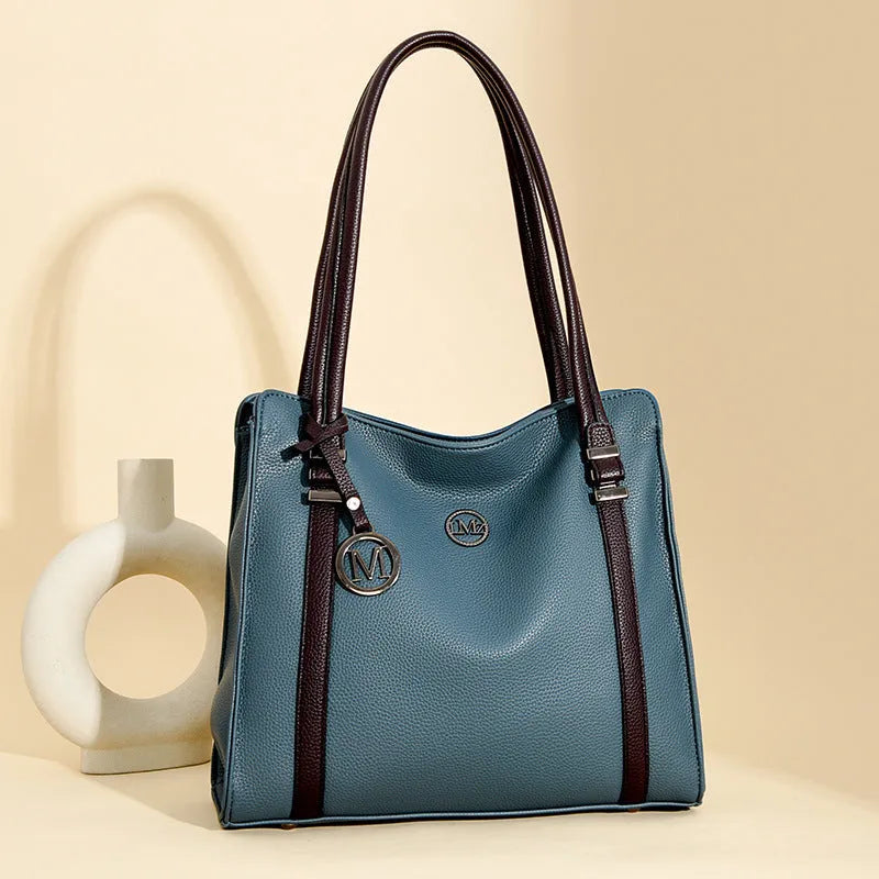 Woman holding a large soft black PU leather retro crossbody bag with double shoulder straps.