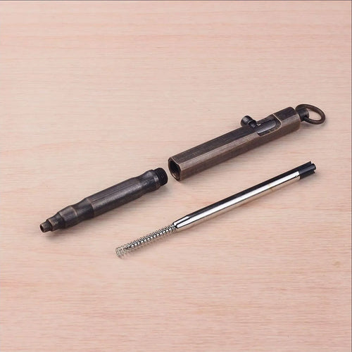 Solid brass tactical pen with hexagonal bolt design in vintage machine gun style on black background.